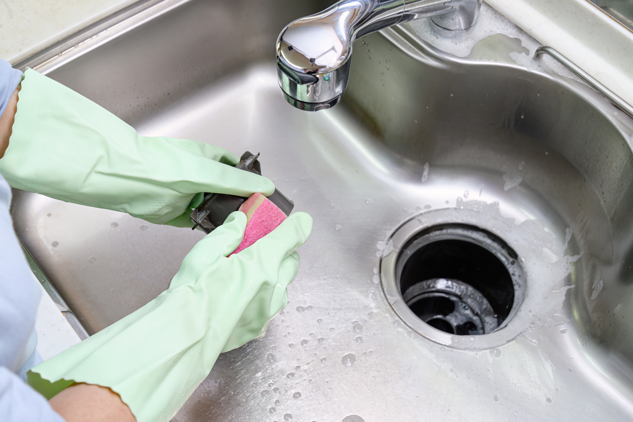 Hands Cleaning a Kitchen Sink