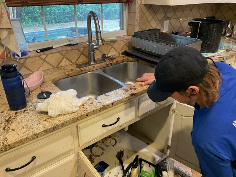 Plumber's hand adjusting a home water valve