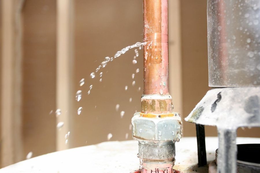 Water leaking out of a pipe on top of a water heater