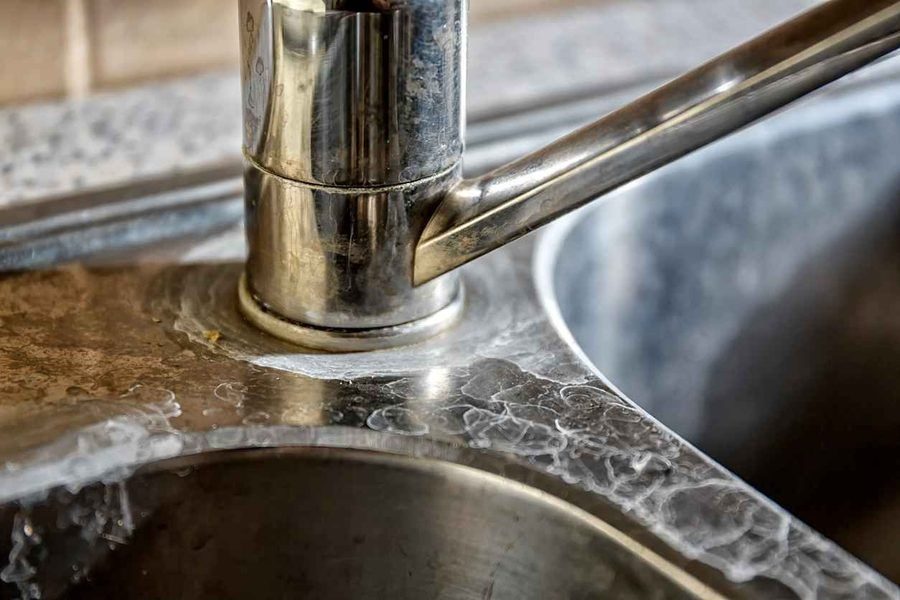 Hard water stains on kitchen faucet