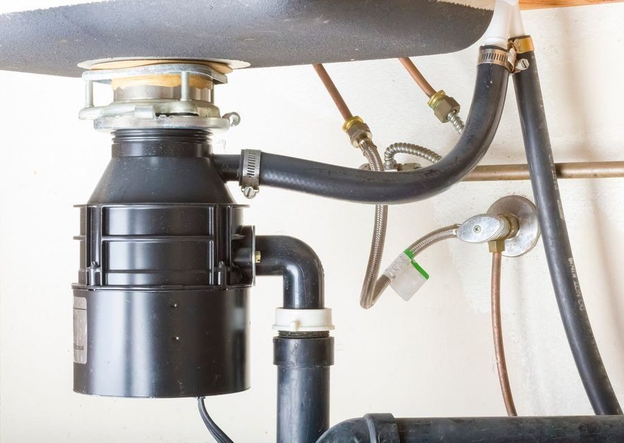 garbage disposal installed beneath a kitchen sink