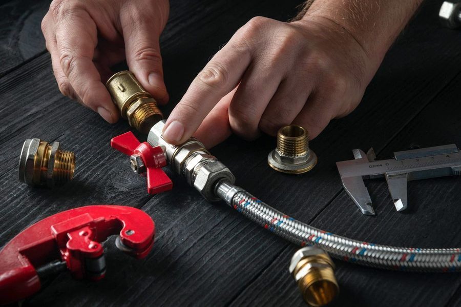 Hands making adjustments to a gas line